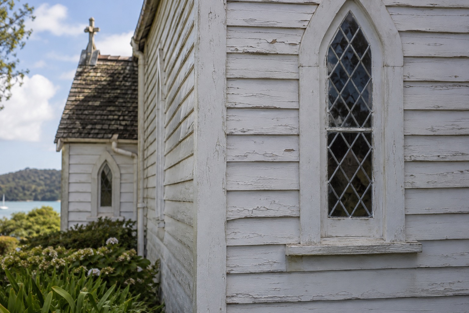 Weathered exterior wall of Christ Church in Russell showing historic musket-ball damage from 1845
