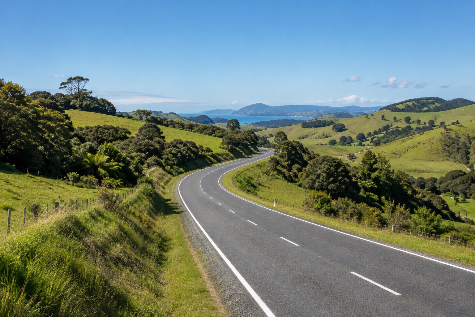 A road through green Northland countryside on the drive north from Auckland to the Bay of Islands